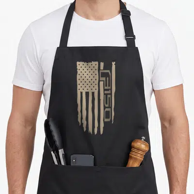 Wandering wheel apron - Tan distressed American flag with vertical F150 lettering on the right side — shown on a black cotton canvas apron against a white background