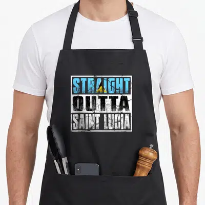 Straight saint lucia apron - Distressed text reading STRAIGHT OUTTA SAINT LUCIA with blue black white and yellow flag — shown on a black cotton canvas apron against a white background