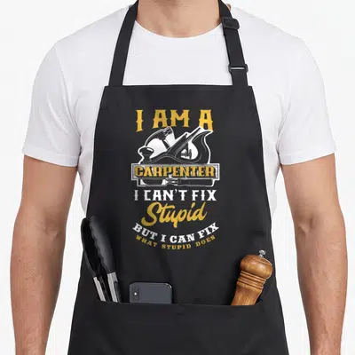 Carpenter stupid aprons - Gold and white carpentry tools with text I can't fix stupid but I can fix what stupid does — shown on a black cotton canvas apron against a white background