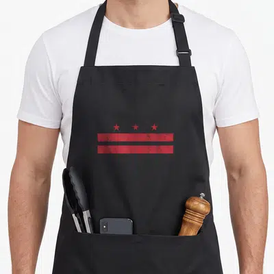 District current river apron - Red distressed Washington DC flag with three stars and two horizontal stripes — shown on a black cotton canvas apron against a white background