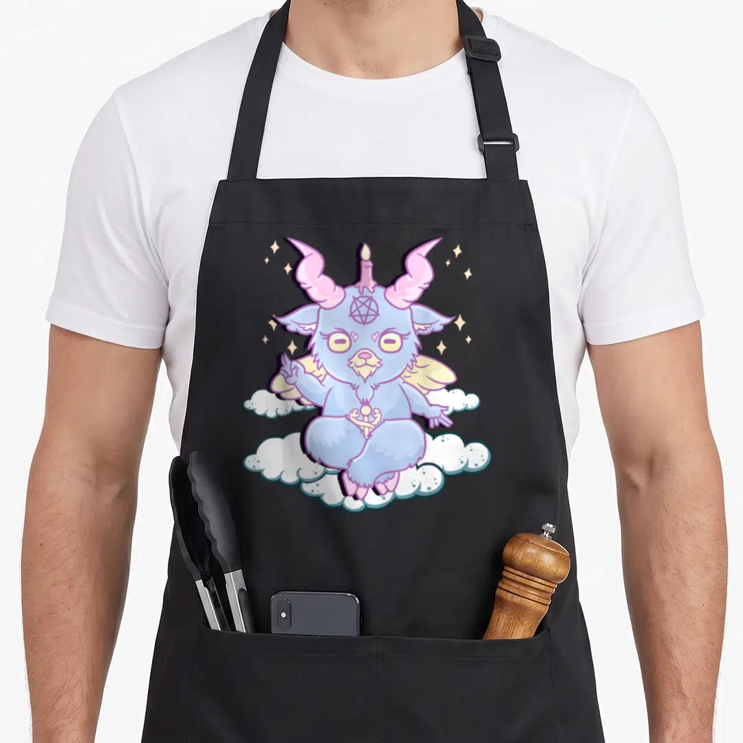 Baphomet anime cooking apron - Cartoon Baphomet in light blue pink white sitting on clouds with candle between horns — shown on a black cotton canvas apron against a white background