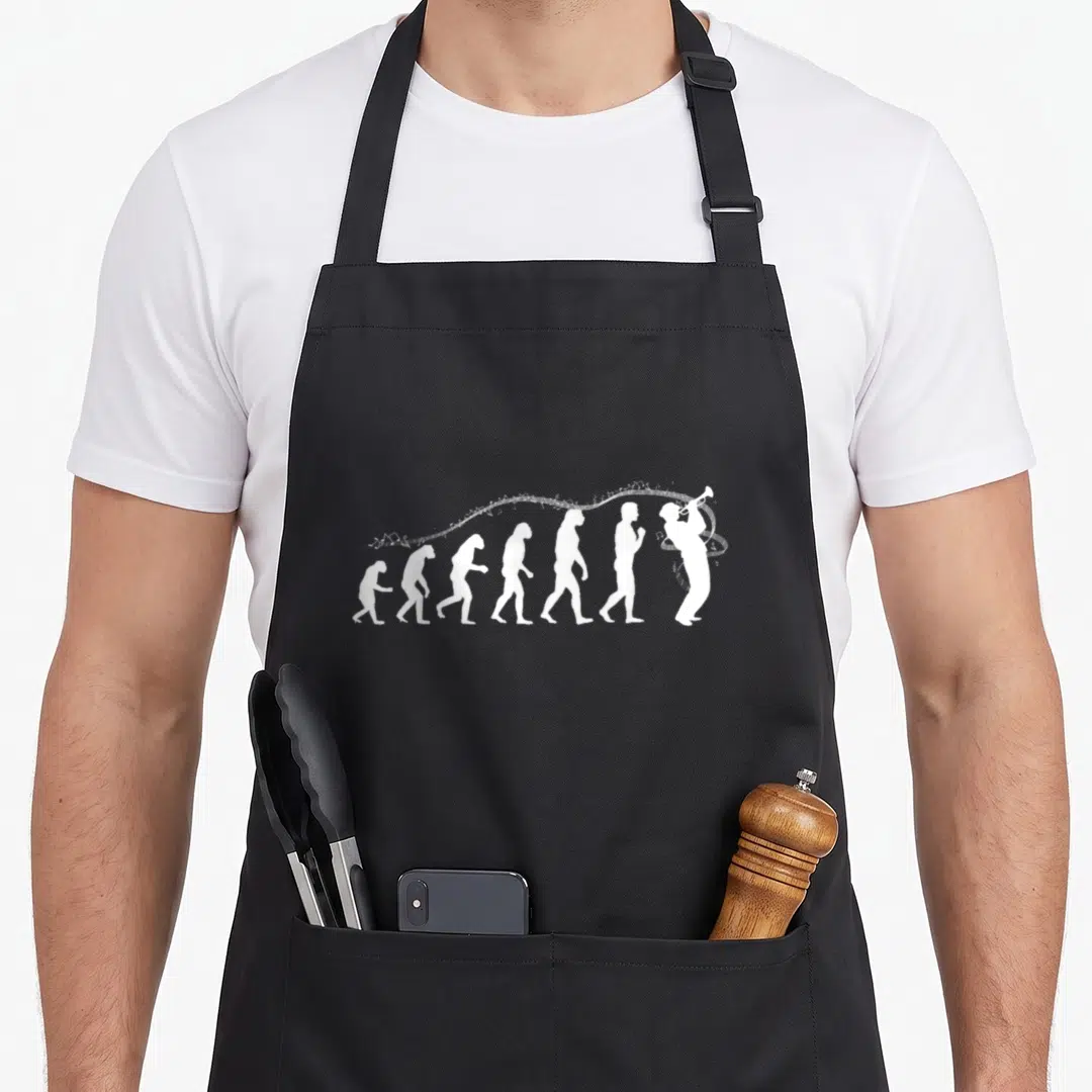 Evolution figure mom apron - White silhouette sequence evolving from ape to trumpet player with musical notes flowing — shown on a black cotton canvas apron against a white background