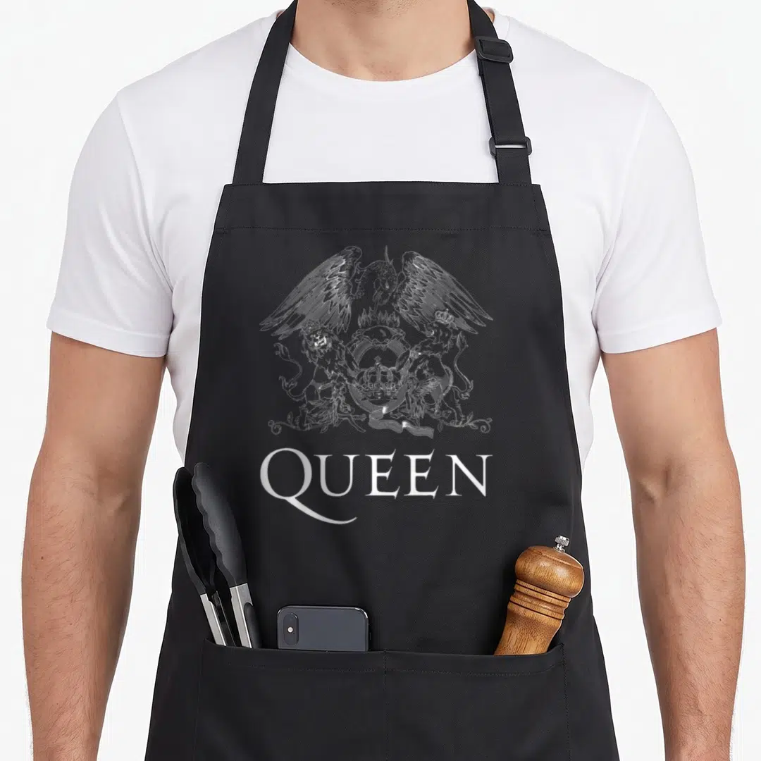 Vintage crest queen apron - White line-art coat of arms with eagle and lions above QUEEN text on black fabric — shown on a black cotton canvas apron against a white background