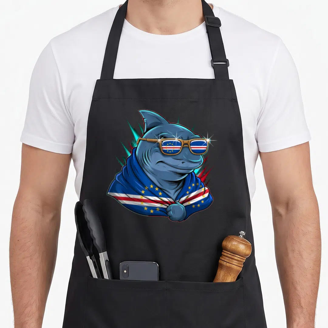 Shark cape verde apron - Cartoon shark in sunglasses and cape with blue red white and gold flag pattern — shown on a black cotton canvas apron against a white background