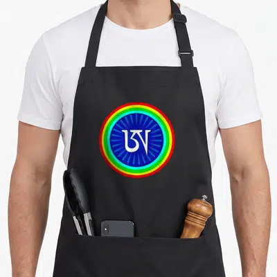 Tibetan colorful aprons - White Om symbol inside blue petals surrounded by red yellow green and light blue concentric — shown on a black cotton canvas apron against a white background