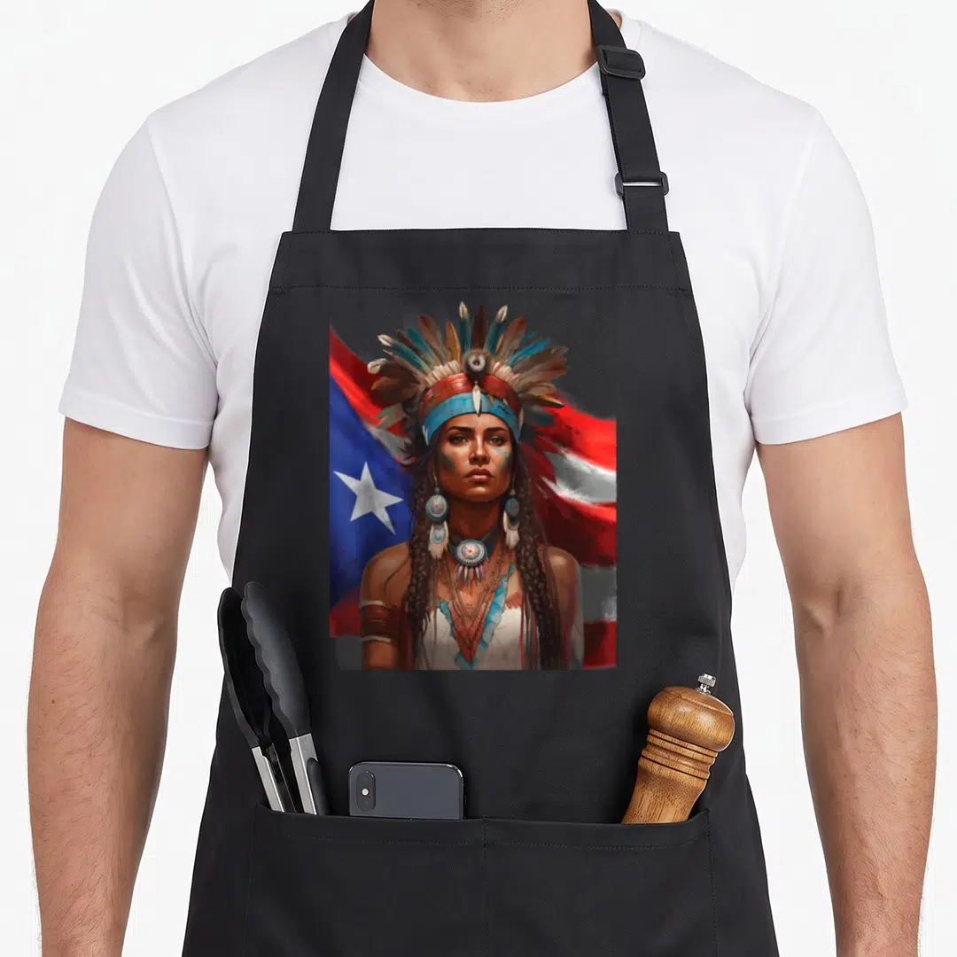 Indigenous rican apron - Realistic woman facing forward with feathered headdress and red blue flag background — shown on a black cotton canvas apron against a white background