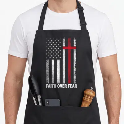 Cross american flag apron - Distressed US flag with red cross and FAITH OVER FEAR text — shown on a black cotton canvas apron against a white background