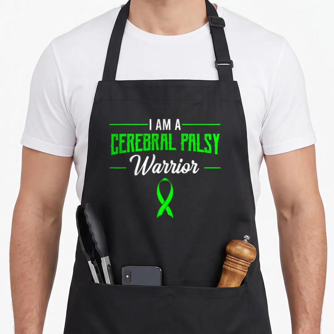 Palsy ribbon apron - Green and white text reading I Am A Cerebral Palsy Warrior above a green ribbon symbol — shown on a black cotton canvas apron against a white background