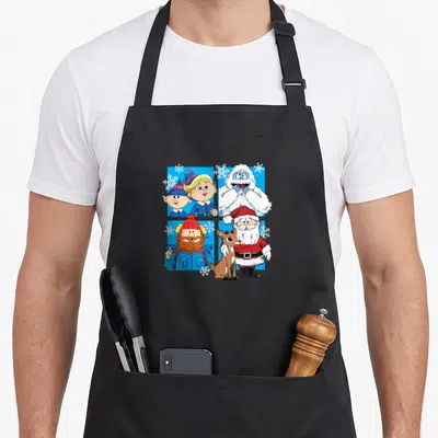 Rudolph santa apron - Four cartoon Christmas characters including Santa and reindeer in a blue grid with white — shown on a black cotton canvas apron against a white background