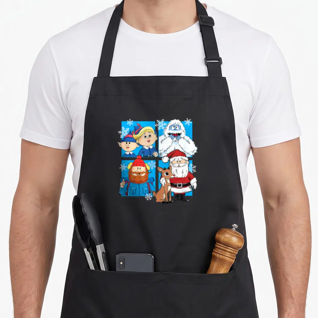 Rudolph santa apron - Four cartoon Christmas characters including Santa and reindeer in a blue grid with white — shown on a black cotton canvas apron against a white background