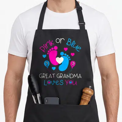 Blue grandmother apron - Pink and blue baby footprints with hearts and question mark balloons surrounding stacked text — shown on a black cotton canvas apron against a white background