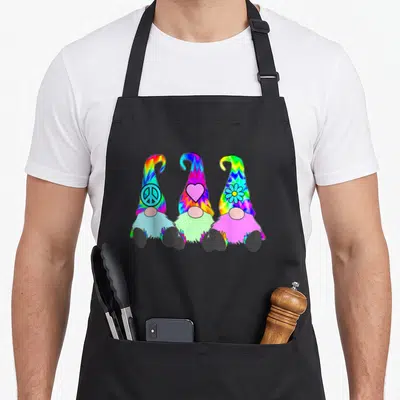Hat tie-dye apron - Three rainbow-hatted gnomes with peace, heart, and flower symbols — shown on a black cotton canvas apron against a white background