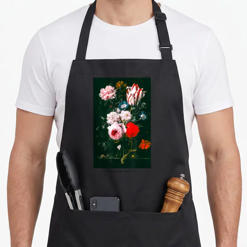 Rose streetwear apron - Vertical floral bouquet with snail and wheat stalk on dark background — shown on a black cotton canvas apron against a white background