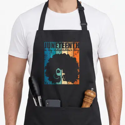Juneteenth independence apron - Retro woman silhouette with afro over blue teal cream orange grey stripes and stacked — shown on a black cotton canvas apron against a white background