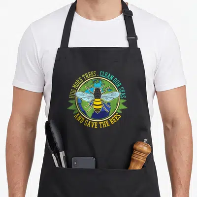 Hug bee aprons - Bee over globe with text HUG MORE TREES CLEAN OUR SEAS SAVE THE BEES — shown on a black cotton canvas apron against a white background
