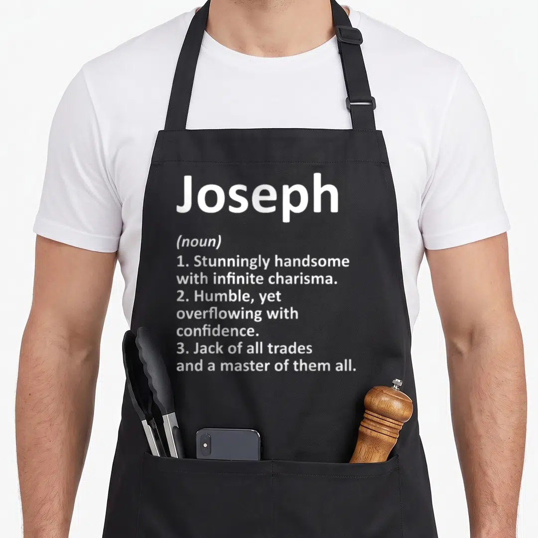 Joseph father day aprons - White dictionary definition text listing Joseph traits on black fabric — shown on a black cotton canvas apron against a white background