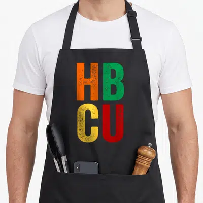 Hbcu history historical aprons - Stacked HB CU letters in orange green yellow and red distressed print — shown on a black cotton canvas apron against a white background