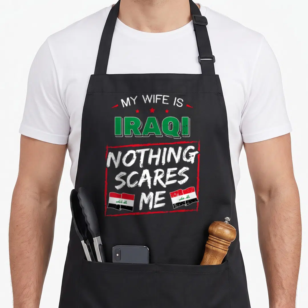 Iraqi wife apron - My Wife Is Iraqi Nothing Scares Me text with three stars and two Iraqi flags — shown on a black cotton canvas apron against a white background