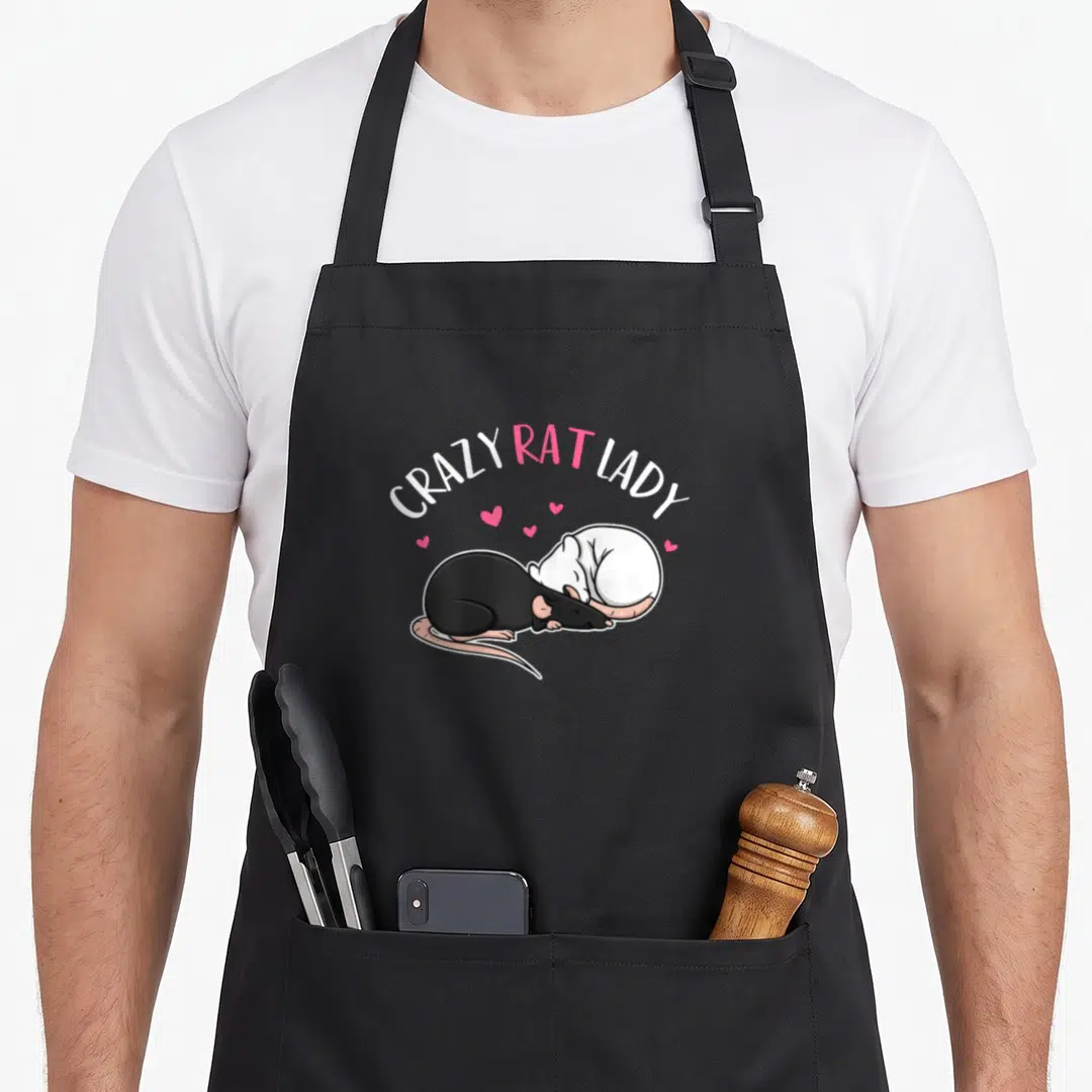 Funny crazy rat lady apron - Two curled rats under arched text with scattered pink hearts in cartoon style — shown on a black cotton canvas apron against a white background