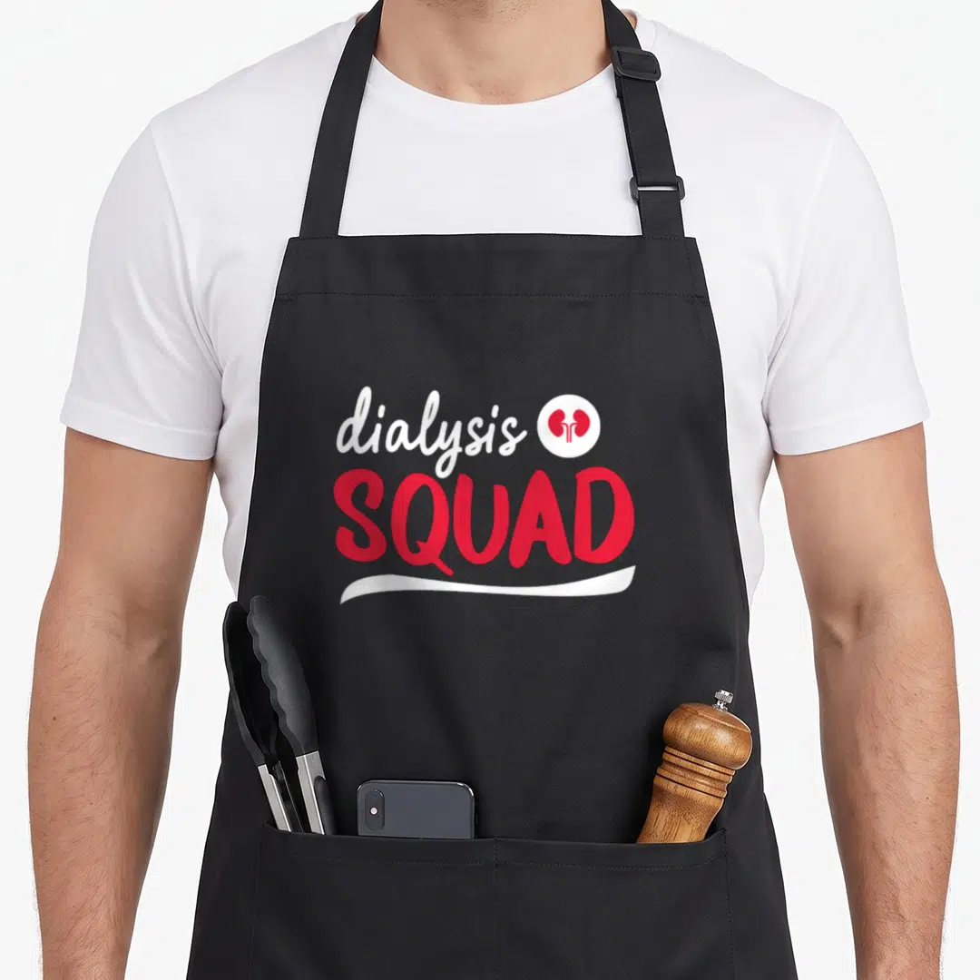 Squad technician nurse apron - Dialysis squad text with red kidneys in white circle and swoosh underline — shown on a black cotton canvas apron against a white background