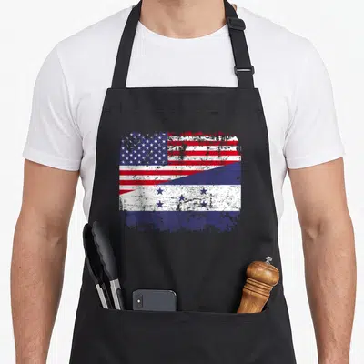 Honduran american flag apron - Distressed USA and Honduras flags split diagonally in red white and blue — shown on a black cotton canvas apron against a white background
