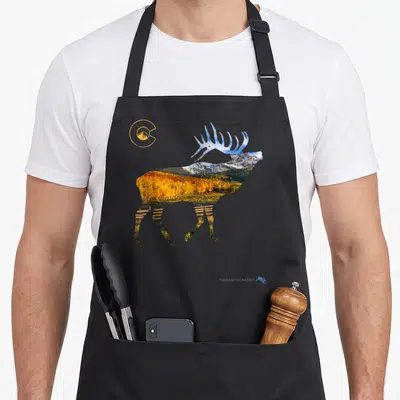 Hunting colorado apron - Elk silhouette filled with mountain landscape, autumn trees, and yellow circular logo — shown on a black cotton canvas apron against a white background
