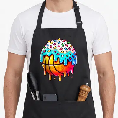 Basketball ice cream apron - Cartoon orange basketball topped with white and blue dripping frosting and colorful — shown on a black cotton canvas apron against a white background