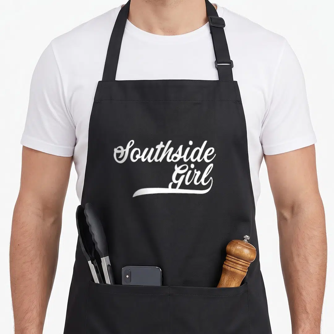 Southside white apron - White script text reading Southside Girl stacked with underline flourish — shown on a black cotton canvas apron against a white background