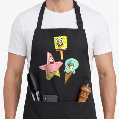 Squarepant ice cream apron - SpongeBob popsicle, pink star treat, and Squidward ice cream cone cartoon illustration — shown on a black cotton canvas apron against a white background