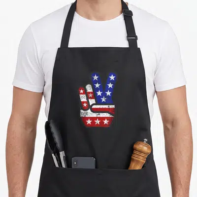 4th fourth of july aprons - Distressed hand making a peace sign filled with red white and blue stars and stripes pattern — shown on a black cotton canvas apron against a white background
