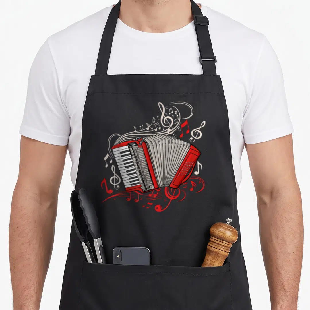 Player accordion apron - Red cartoon accordion surrounded by swirling white and red musical notes and staff lines — shown on a black cotton canvas apron against a white background