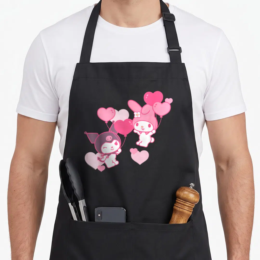 Funny valentine's day apron - My Melody and Kuromi holding pink heart balloons in cartoon style with purple and white — shown on a black cotton canvas apron against a white background