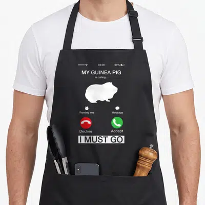 Calling pig lady apron - Smartphone call screen graphic with white guinea pig silhouette, red decline button, green — shown on a black cotton canvas apron against a white background