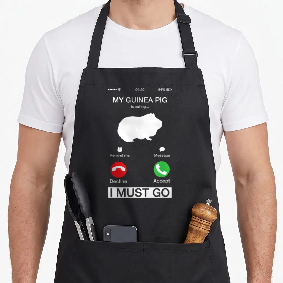 Calling pig lady apron - Smartphone call screen graphic with white guinea pig silhouette, red decline button, green — shown on a black cotton canvas apron against a white background