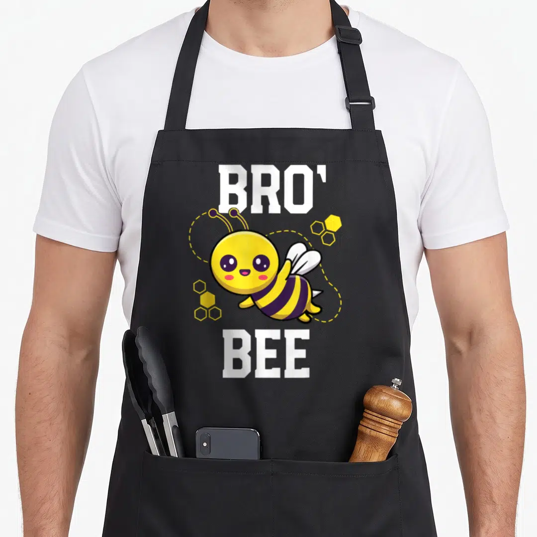 Family bee aprons - Cartoon bee with yellow and black stripes, white wings, and BRO BEE text — shown on a black cotton canvas apron against a white background