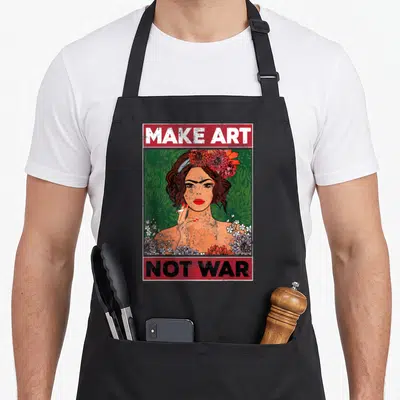 War painter apron - Retro poster of a woman with flowers and red banners reading MAKE ART NOT WAR — shown on a black cotton canvas apron against a white background
