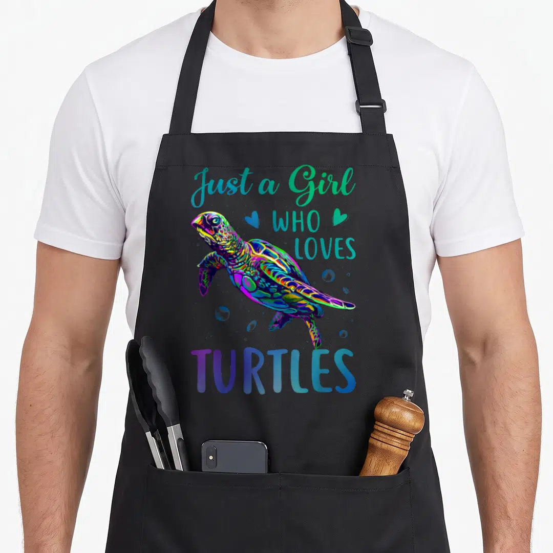 Watercolor turtle lover apron - Neon cartoon turtle swimming among hearts and bubbles with split text design — shown on a black cotton canvas apron against a white background