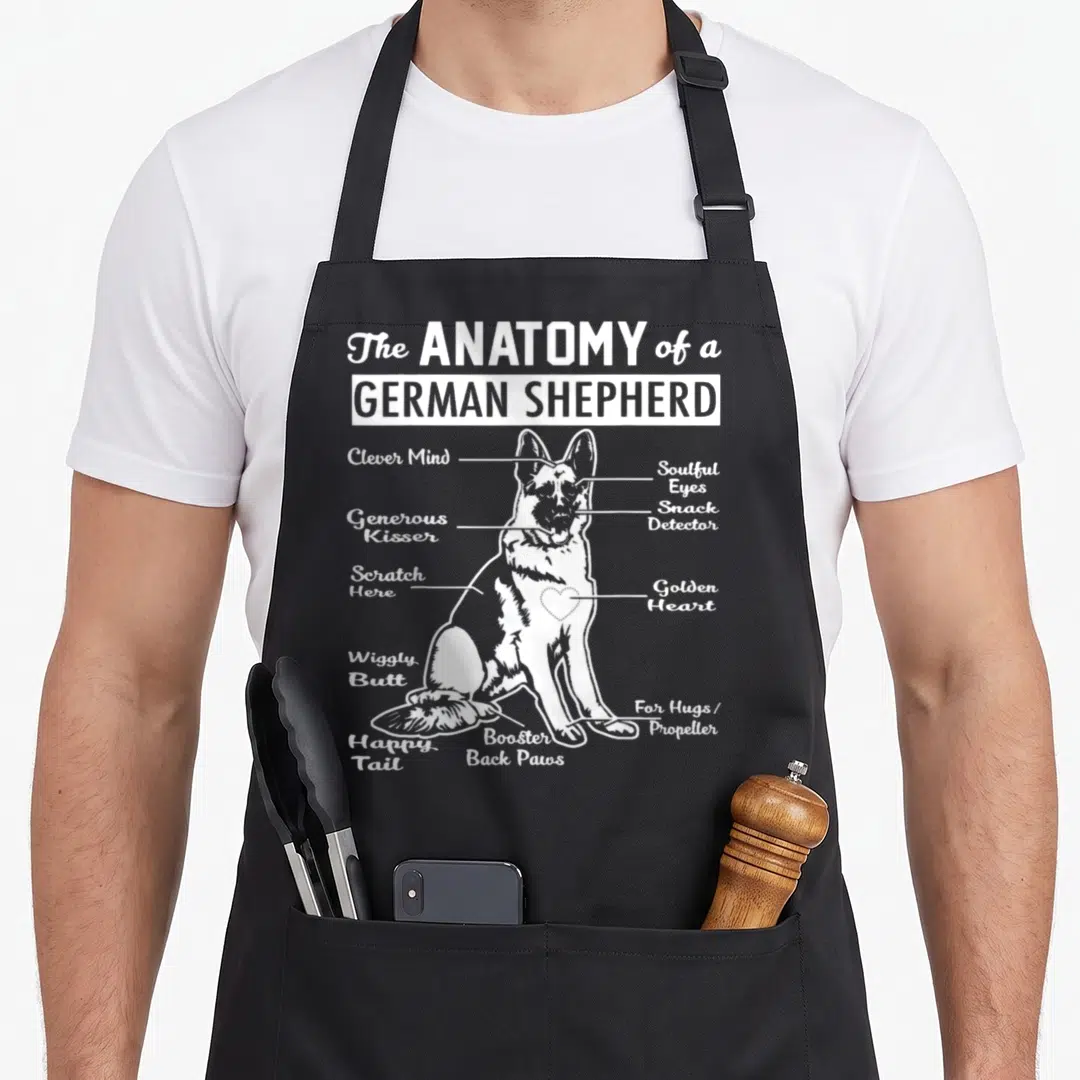 Anatomy german apron - White German Shepherd diagram with labels Clever Mind Golden Heart and Happy Tail pointing — shown on a black cotton canvas apron against a white background