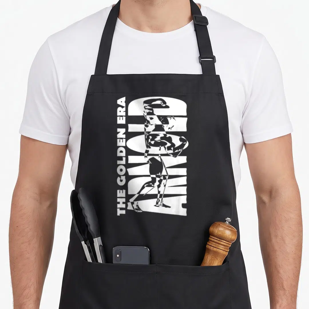 Era golden apron - Vertical The Golden Era Arnold text with integrated bodybuilder silhouette in white minimalist print — shown on a black cotton canvas apron against a white background