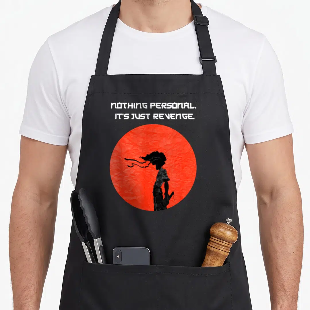 Samurai cartoon apron - Red circle with black silhouette and text NOTHING PERSONAL IT'S JUST REVENGE — shown on a black cotton canvas apron against a white background
