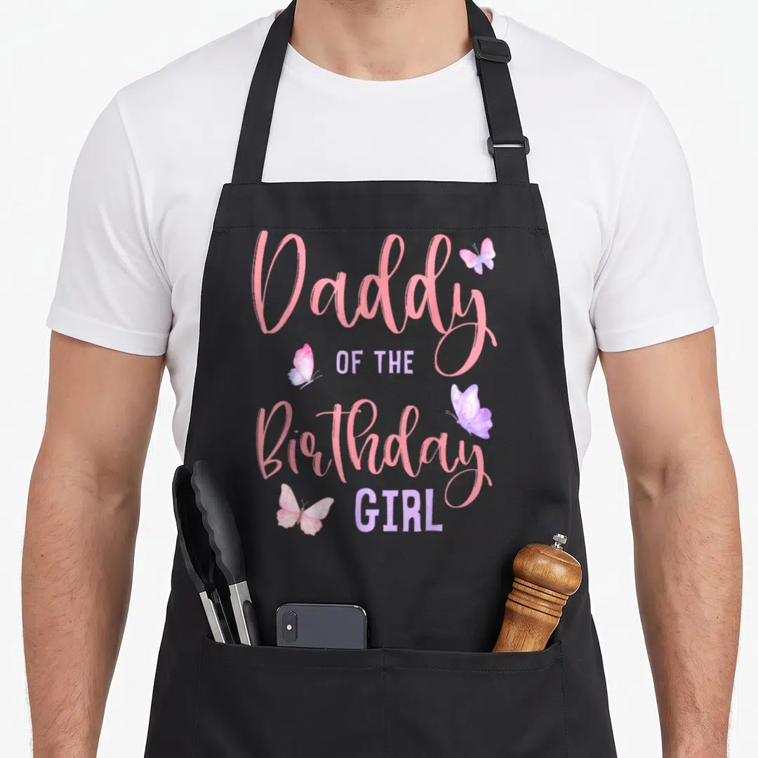 Daddy butterfly aprons - Pink and purple text reading Daddy OF THE Birthday GIRL with four scattered butterflies — shown on a black cotton canvas apron against a white background