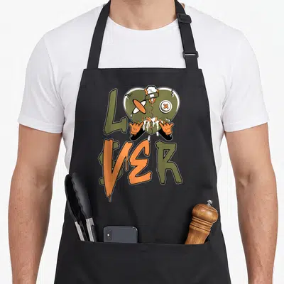 Funny loser drip apron - Cracked olive heart character with shaka hands above LOVER text in orange and olive drips — shown on a black cotton canvas apron against a white background