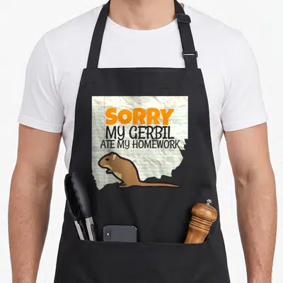 Gerbil teacher apron - Cartoon gerbil on crumpled lined paper with SORRY MY GERBIL ATE MY HOMEWORK text — shown on a black cotton canvas apron against a white background