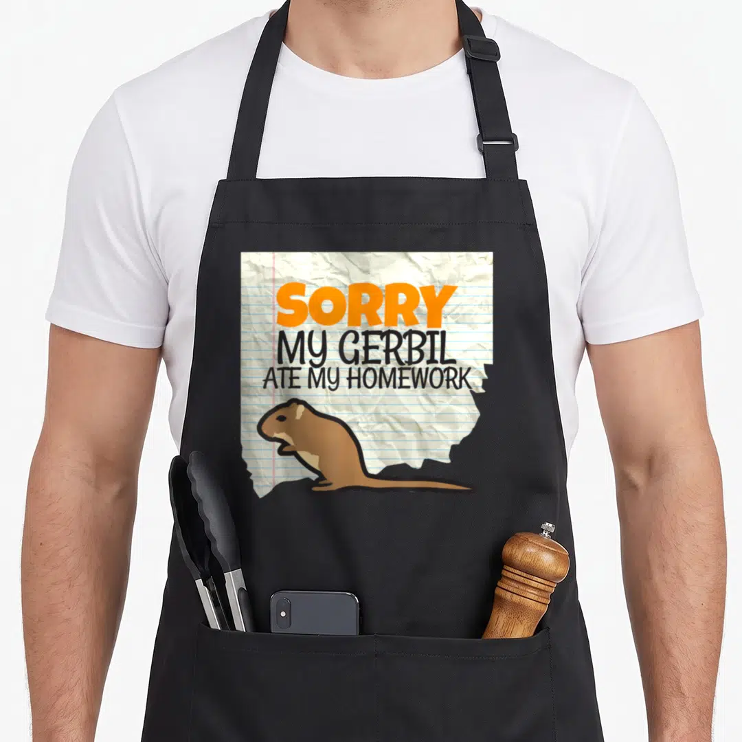 Gerbil teacher apron - Cartoon gerbil on crumpled lined paper with SORRY MY GERBIL ATE MY HOMEWORK text — shown on a black cotton canvas apron against a white background