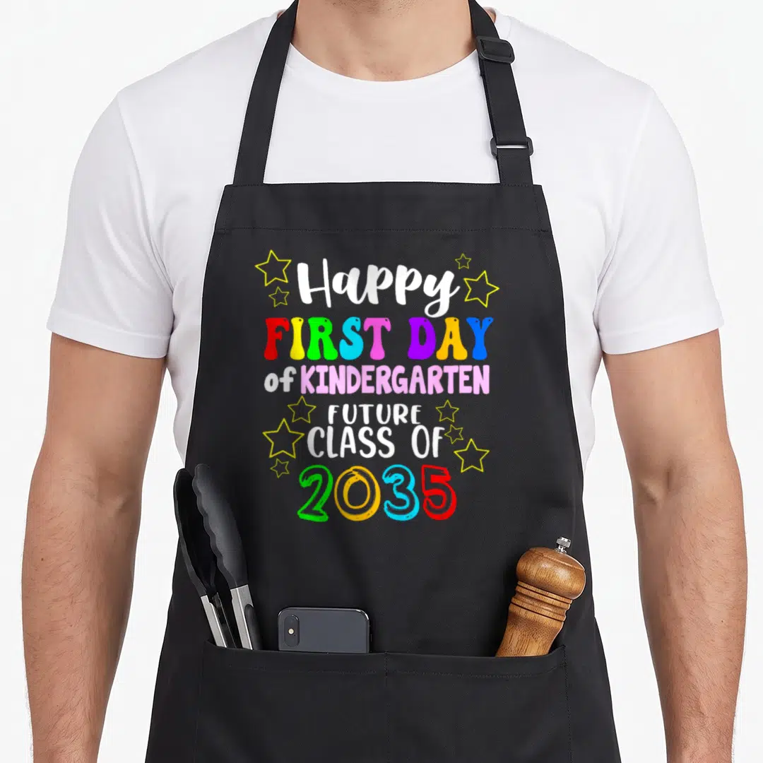Kindergarten class hello apron - Stacked colorful text reading Happy First Day of Kindergarten Future Class of 2035 — shown on a black cotton canvas apron against a white background
