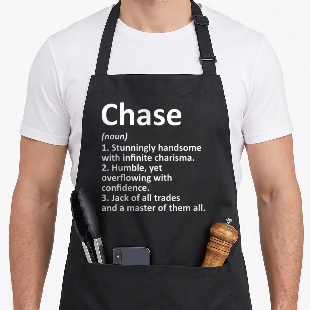 Chase father day aprons - White text defining Chase as handsome, humble, and a jack of all trades — shown on a black cotton canvas apron against a white background