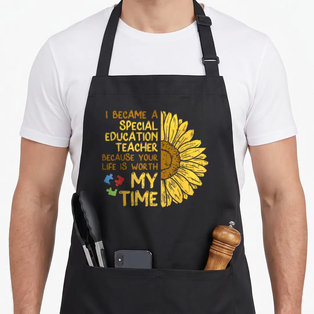 Sunflower teacher art apron - Stacked text I became a special education teacher beside half sunflower and three colored — shown on a black cotton canvas apron against a white background