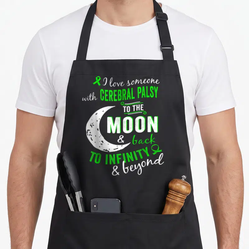 Funny cerebral palsy awareness apron - I love someone with cerebral palsy to the moon text with white crescent — shown on a black cotton canvas apron against a white background