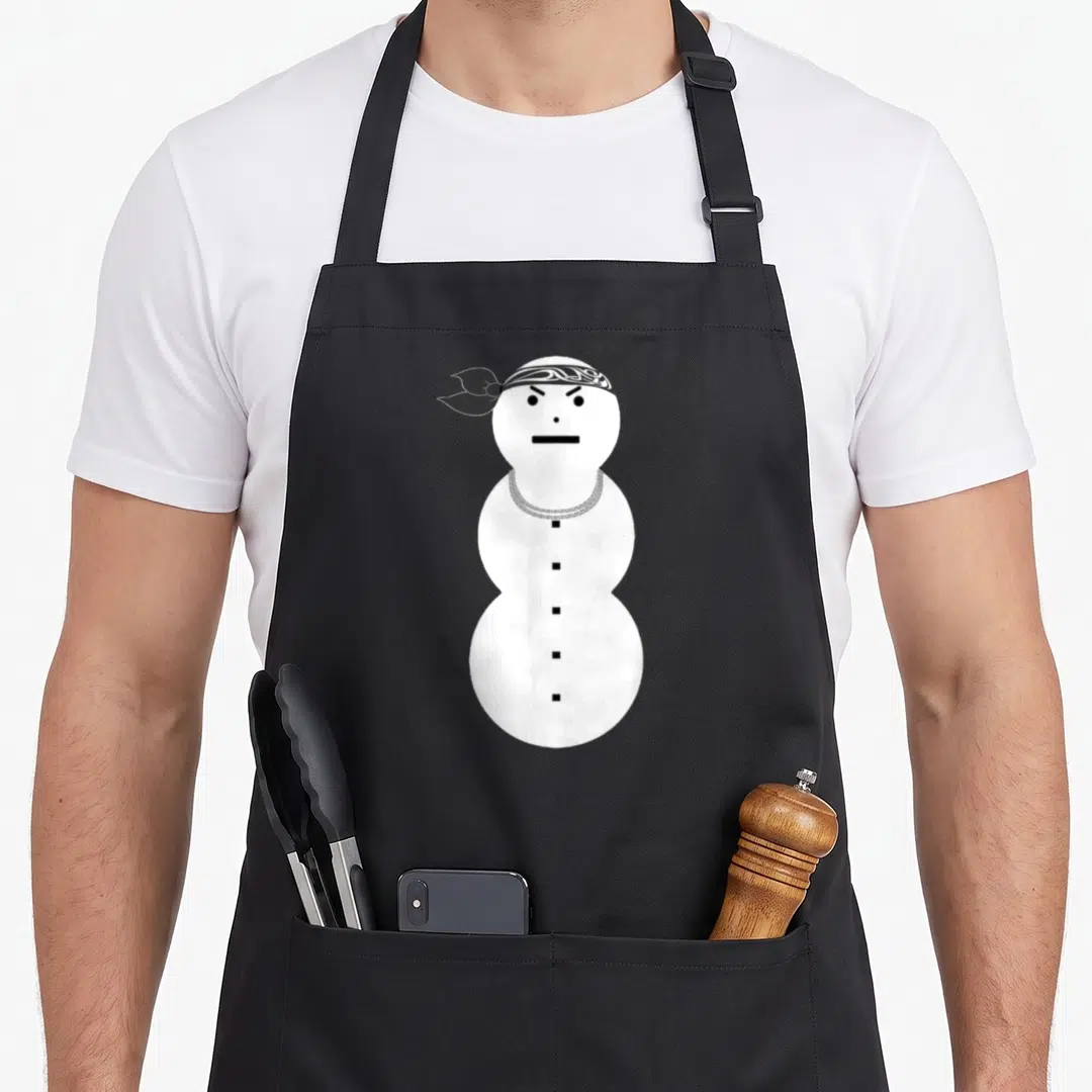 Necklace snowman apron - Angry white snowman cartoon wearing a black patterned bandana and silver chain necklace — shown on a black cotton canvas apron against a white background