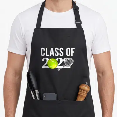 Graduation racquetball apron - CLASS OF 2022 text with lime green tennis ball and white racket graphic — shown on a black cotton canvas apron against a white background